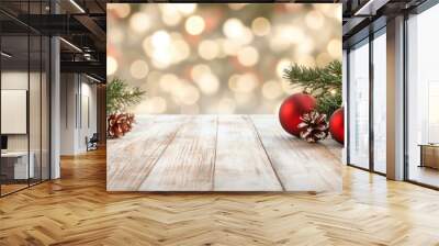 Festive Christmas ornaments and pine branches arranged on a rustic wooden table. Wall mural