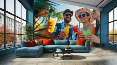 Friends enjoying colorful drinks on a sunny day. A group of friends happily enjoying colorful beverages on a sunny summer day, with palm leaves in the foreground Wall mural