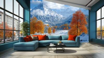 Snow-covered mountains with bright orange trees in the foreground under a clear blue sky. Perfect for winter and autumn photography. Wall mural