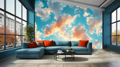 Vibrant clouds illuminated by the golden hues of sunset, floating in a bright blue sky. Ideal for backgrounds, inspirational, and nature-themed content Wall mural