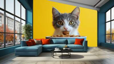 Gray and white cat eating cat food from bowl on bright yellow background. The concept of healthy eating your beloved pet, Generative AI Wall mural