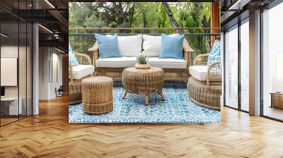 a cozy and inviting outdoor patio setup. It features a wicker sofa and two wicker chairs, all with white and blue cushions Wall mural