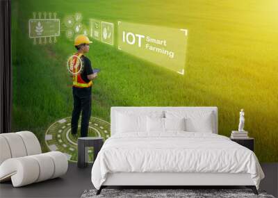 Professional engineer stands confidently, holding a tablet in hand, as he oversee the implementation of IOT technology in smart farming, revolutionizing the agricultural industry. Wall mural