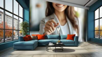 Close up focus on keys, smiling woman realtor selling apartment or car, offering to client, showing at camera, contract, making purchasing deal, real estate agent, mortgage or rent concept Wall mural