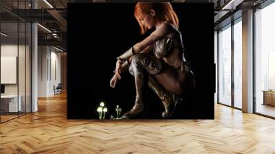 Side portrait of a fantasy red headed warrior female posing on a reflective surface after a unique mystical discovery with a black background. 3d rendering Wall mural