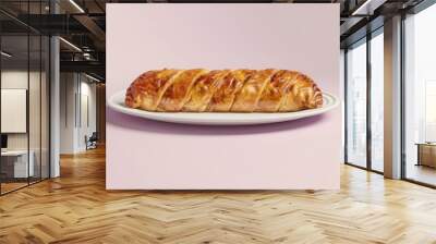 A golden-brown pastry loaf with a flaky crust on a white oval platter Wall mural