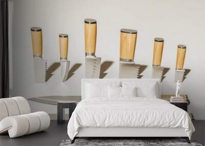 A Set of Eight Stainless Steel Kitchen Knives with Wooden Handles Wall mural