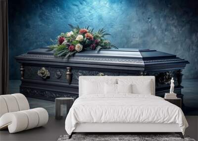 Dark grey coffin with ornate handles and intricate carvings, surrounded by elegant floral arrangements, set against a somber, gradient blue background with subtle texture. Wall mural