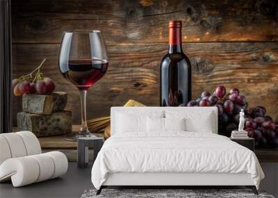 Elegant still life of a bottle and glass of rich red wine accompanied by fresh grapes and artisanal cheese on a rustic wooden surface. Wall mural