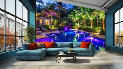 Luxurious nighttime outdoor pool area illuminated by vibrant purple and blue LED lights amidst lush tropical greenery and grand architecture. Wall mural