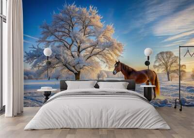 Majestic horse stands alone in serene snow-covered meadow surrounded by bare winter trees under a crisp blue morning sky. Wall mural