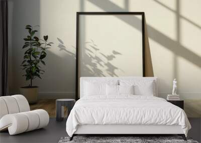 Minimalist interior with a blank frame and a potted plant Wall mural