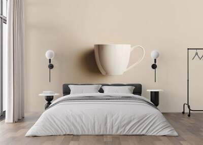 White ceramic teacup with handle on a beige background Wall mural