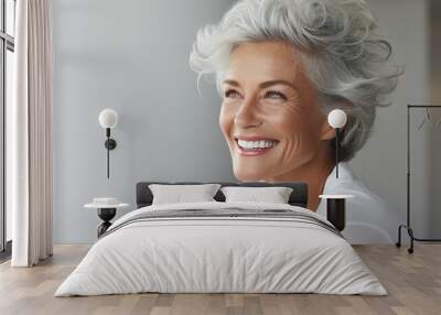 Elderly woman with gray hair is laughing and smiling, mature old lady with healthy face ans skin and white teeth Wall mural