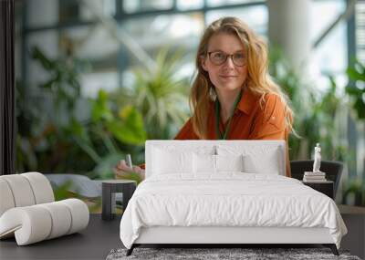 Leading a Sustainable Future: Woman Organizing an Energy Efficiency Seminar for Business Staff Wall mural