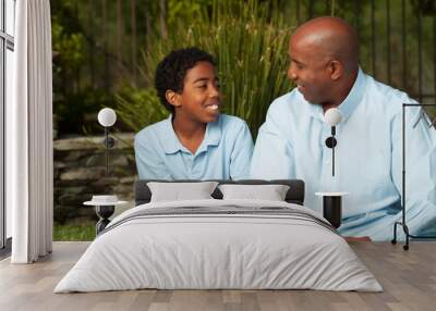 African American father and son talking and laughing. Wall mural