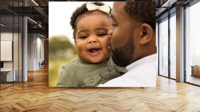 African American father holding his daughter. Wall mural