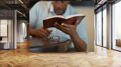 African American man praying and reading the Bible. Wall mural