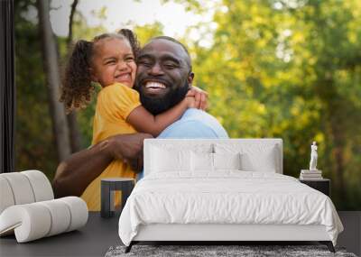 Father laughing and playing with his daugher. Wall mural