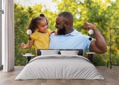 Father laughing and playing with his daugher. Wall mural