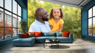 Father laughing and playing with his daugher. Wall mural