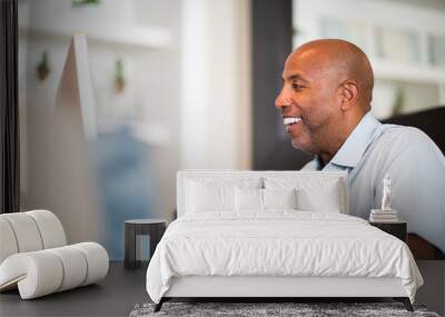 Mature African American man working from his home office. Wall mural