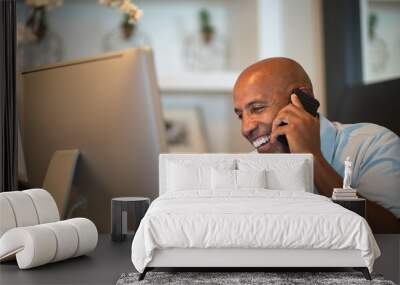 Mature African American man working from his home office. Wall mural