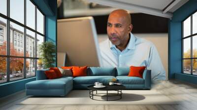 Mature African American man working from his home office. Wall mural