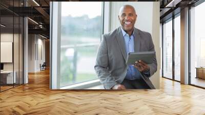 Mature African American man working on a tablet. Wall mural