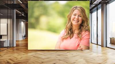 Portrait of a happy woman smiling outside. Wall mural