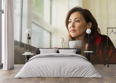 Portrait of a mature Asian woman in deep thought. Wall mural