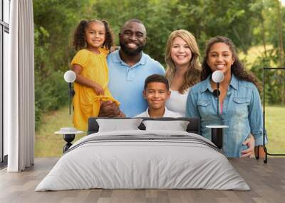 Portrait of a multi ethnic family laughing. Wall mural