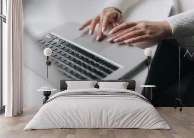 Woman hands are typing on the laptop keyboard, close-up. Focused young business woman professional carefully typing on laptop computer keyboard. Wall mural