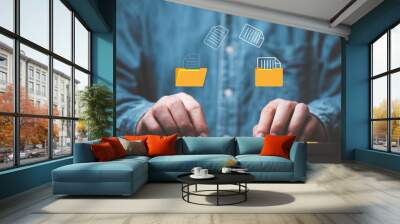 Businessman hand using laptop computer with data folder file icon for information exchange and transfer concept. Wall mural