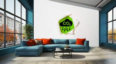 CO2 reducing icon on green background and white punch for decrease CO2 or carbon dioxide emission ,carbon footprint and carbon credit to limit global warming from climate change concept. Wall mural