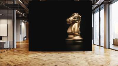 Golden knight horse chess on black background, business strategy concept. Wall mural