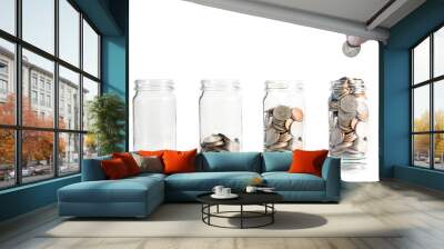 Hand putting coin in jar for saving and investment concept. Wall mural