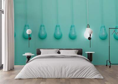 One hanging light bulb glowing from others bulbs on blue background for outstanding ,different creative thinking idea and innovation concept by 3d render. Wall mural