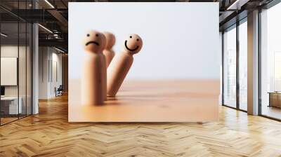 smile face on wooden figure out of line from sad face with copy space for positive mindset selection concept. Wall mural