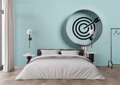 Target board inside of magnifier glass for focus business objective on blue background and copy space. Wall mural