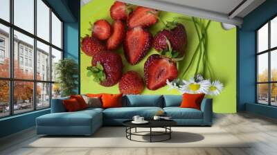 strawberry slice red background on a green board with flowers. close up top view Wall mural