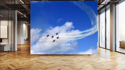 airplane in formation in the bright blue sky and clouds Wall mural