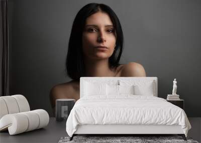 Portrait of beautiful young woman with bare shoulders. Studio Wall mural