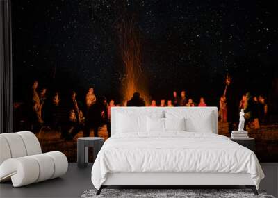 beautiful scenery of night vision. bonfire around people. basking by the fire at night. the concept of outdoor activities. Wall mural