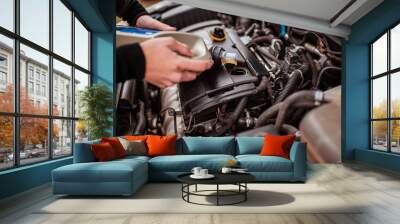 Change the oil, close the selective focus. replacing the fluid in the car. equipment maintenance. Replacing the fluid in the car.  An auto mechanic works and repairs the car. Car service. Wall mural