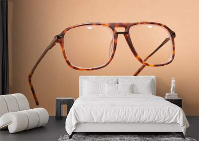 Retro style glasses on pastel beige background. Levitation spectacles in air. Wall mural