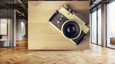 Vintage photo camera on a wooden table Wall mural