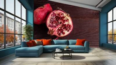 pomegranate on a wooden board on a black background Wall mural