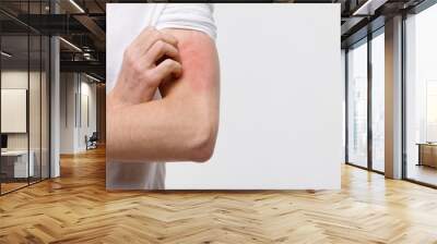 Close up of male scratching the itch on his hand, isolated on grey background, copy space. Pruritus, animal/food/cosmetic allergy, dermatitis, insect bites, irritation concept.  Wall mural