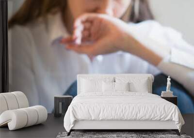 Crying woman in depression looking at phone gets bad news, covering mouth with hand, focus on the phone Wall mural